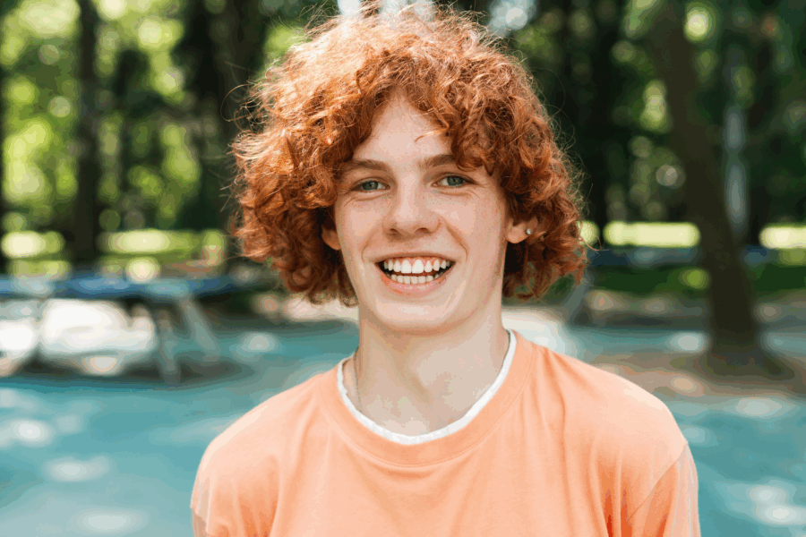 Smiling red-haired teen enjoying the outdoors, symbolizing the confidence, comfort, and personalized care delivered through the Palencia Promise